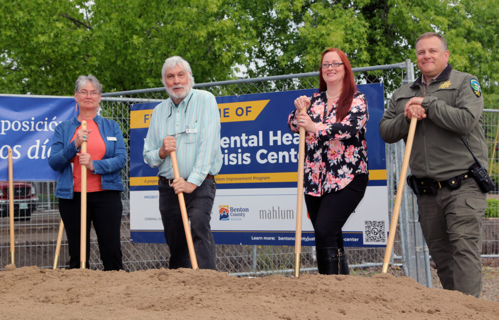 Commissioners Augerot, Malone and Wyse, and Sheriff Van Arsdall each hold a shovel after breaking ground and the new mental health crisis center in downtown Corvallis.