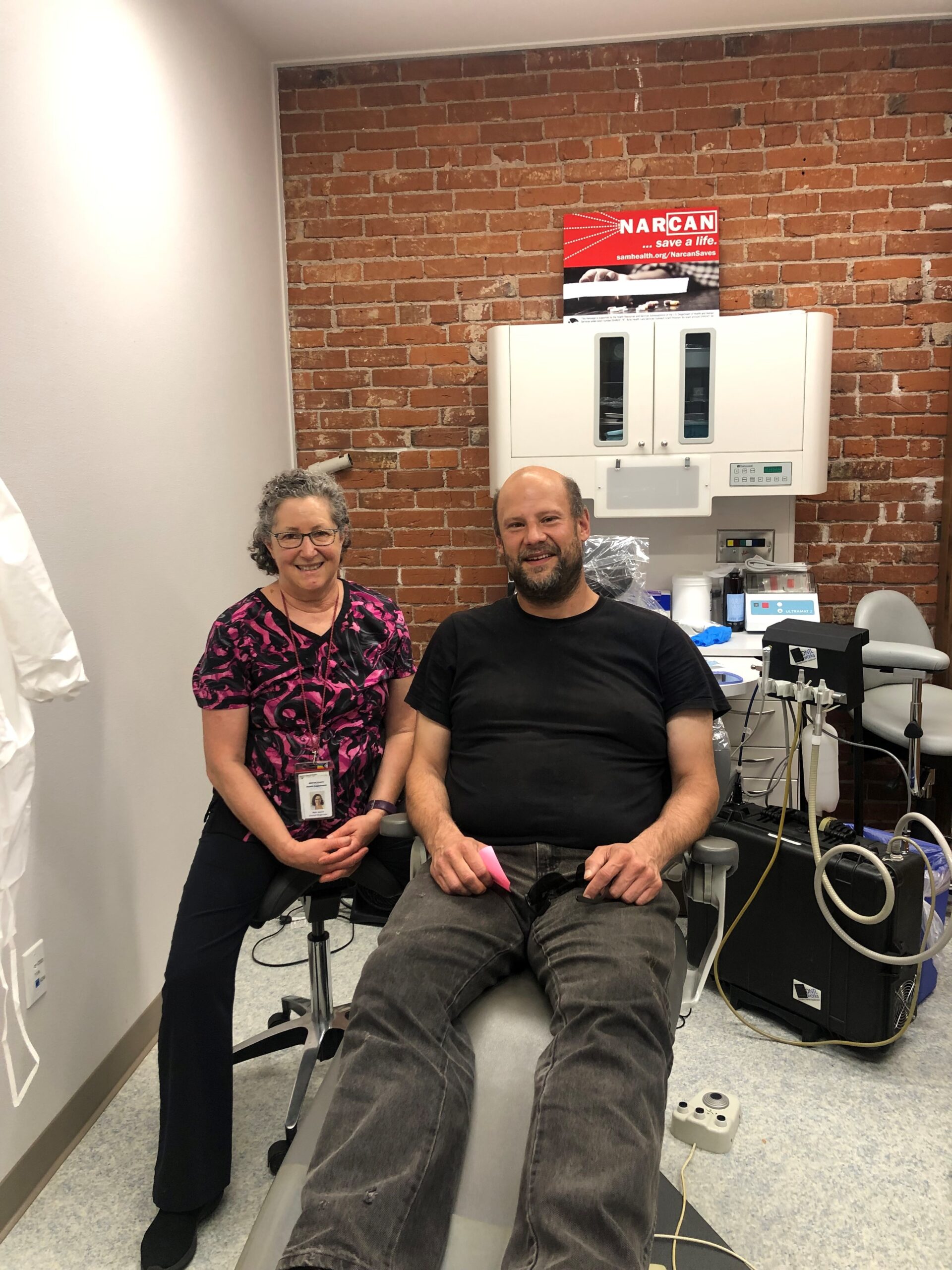 A patient pauses for a photo with a dental care professional at the C.H.A.N.C.E clinic in Albany, Oregon.