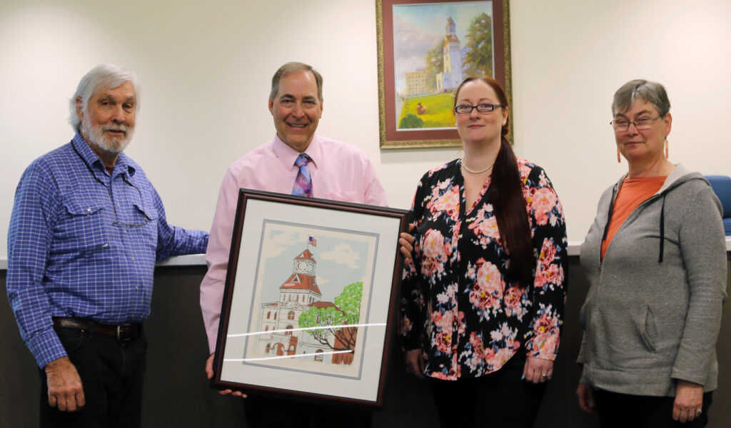 Left to right: Commissioner Malone, County Administrator Joe Kerby, Commissioner Wyse, and Commissioner Augerot. The Board of Commissioners present Joe Kerby with a picture of the Benton County Courthouse after 5 years of services as the County Administrator.