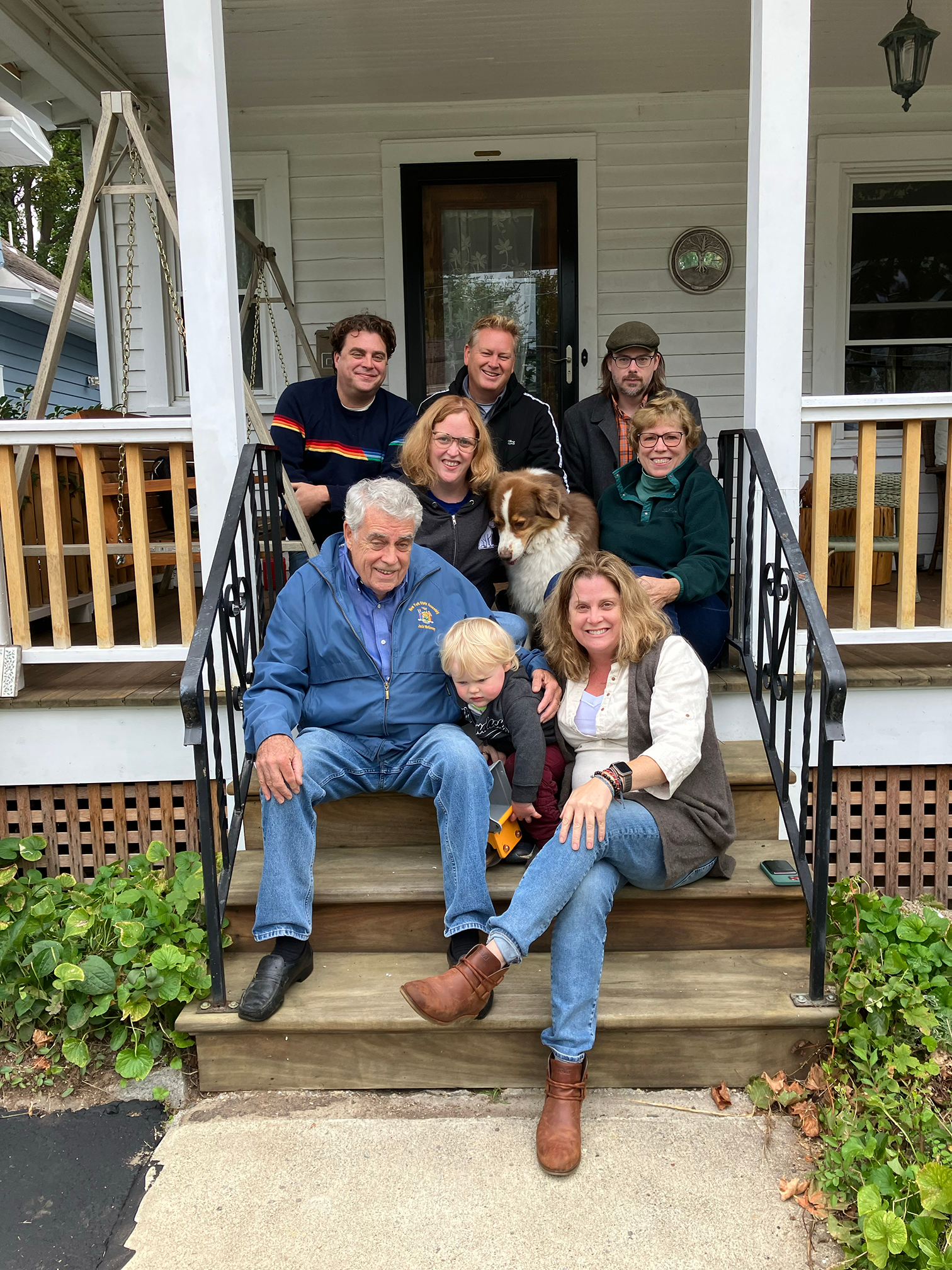 Rachel McEneny sits on her front porch in Albany, New York with her family and dog, Yaeger, before she leaves on her journey to Corvallis, Oregon.