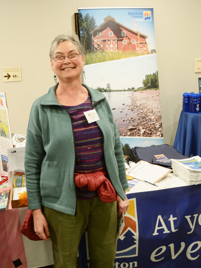 Commissioner Augerot stands in front of Benton County's table at the 2024 Sustainability Fair.