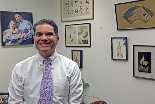 Deputy DA Kevin Hashizume with family pictures and memorabilia