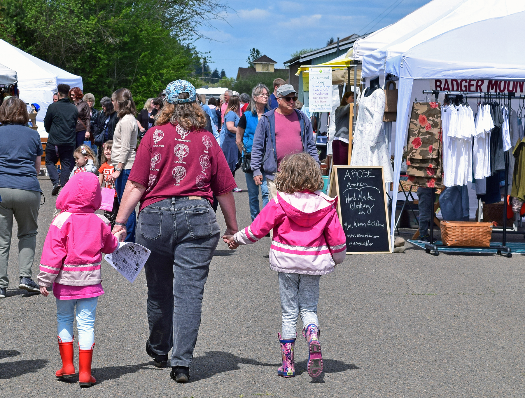 Visitors stroll between booths at the Monroe Festival