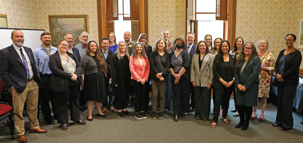 State Court Administrator Nancy Cozine, center left, and Oregon Supreme Court Chief Justice Meagan Flynn, center right, pose with local attorneys, elected officials, Benton County leadership and community members during a reception at the Benton County Courthouse on Tuesday, June 3.